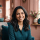 A friendly and professional portrait of a smiling Indian woman, representing a happy and satisfied customer.